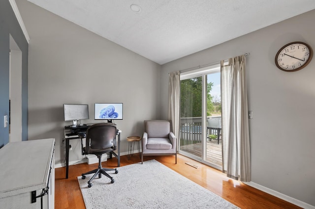 14380 Geneva Ave N, Hugo, MN 55038 - office with vaulted ceiling, wood finished floors, and baseboards
