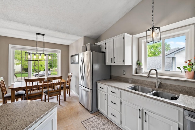 14380 Geneva Ave N, Hugo, MN 55038 - kitchen featuring a sink, white cabinets, appliances with stainless steel finishes, hanging light fixtures, and light tile patterned flooring