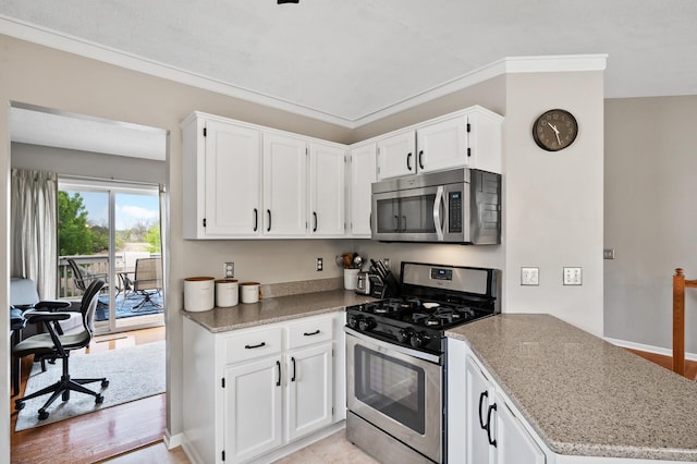 14380 Geneva Ave N, Hugo, MN 55038 - kitchen featuring appliances with stainless steel finishes, white cabinets, light stone countertops, and a peninsula