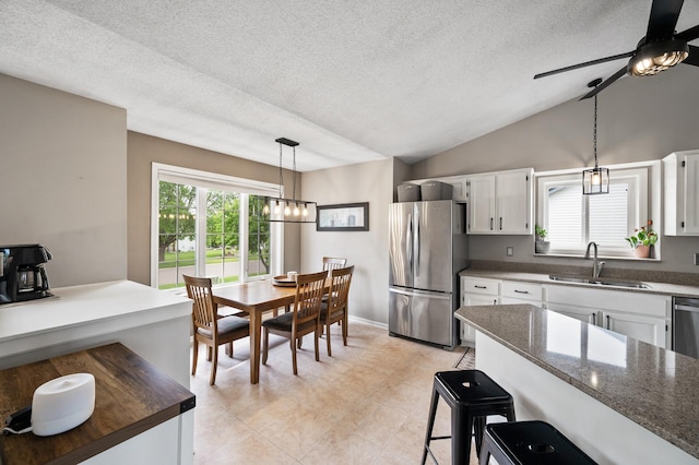 14380 Geneva Ave N, Hugo, MN 55038 - kitchen featuring freestanding refrigerator, a sink, a textured ceiling, ceiling fan, and white cabinets