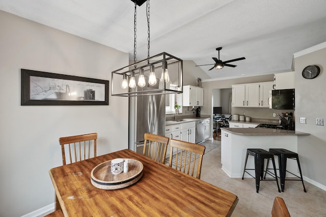 14380 Geneva Ave N, Hugo, MN 55038 - dining space with vaulted ceiling, baseboards, a ceiling fan, and light tile patterned floors