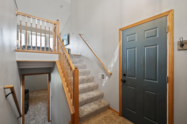 14380 Geneva Ave N, Hugo, MN 55038 - stairway featuring a towering ceiling and baseboards