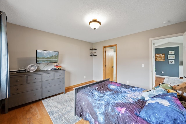 14380 Geneva Ave N, Hugo, MN 55038 - bedroom with light wood-style floors, a textured ceiling, and baseboards