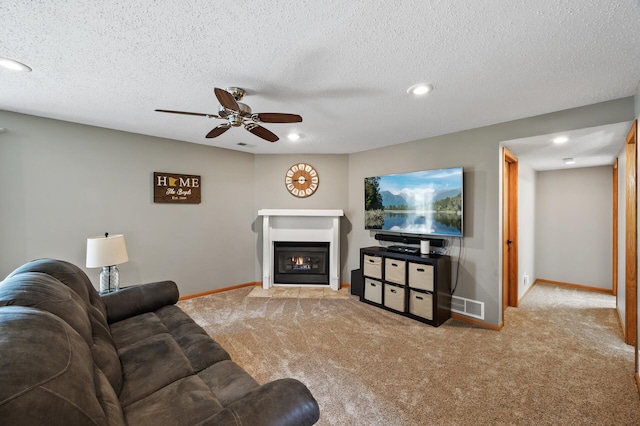 14380 Geneva Ave N, Hugo, MN 55038 - carpeted living room with baseboards, a ceiling fan, a glass covered fireplace, recessed lighting, and a textured ceiling