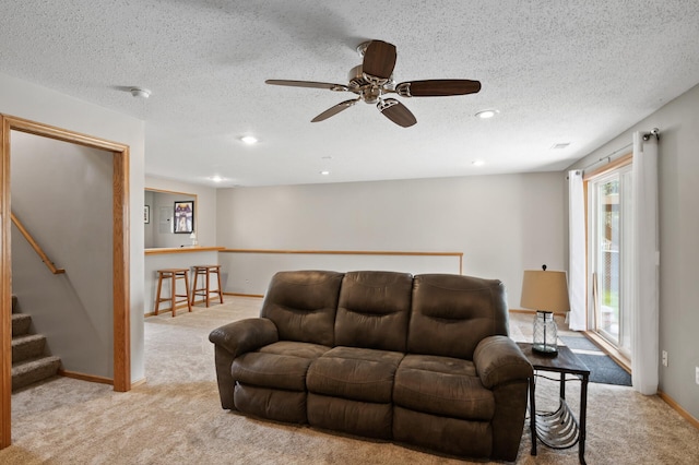 14380 Geneva Ave N, Hugo, MN 55038 - carpeted living room featuring ceiling fan, stairs, a textured ceiling, recessed lighting, and baseboards