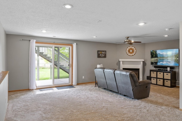 14380 Geneva Ave N, Hugo, MN 55038 - carpeted living room with a ceiling fan, recessed lighting, a glass covered fireplace, a textured ceiling, and baseboards