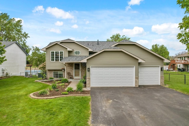 14380 Geneva Ave N, Hugo, MN 55038 - view of front of house featuring a shingled roof, asphalt driveway, a garage, and brick siding