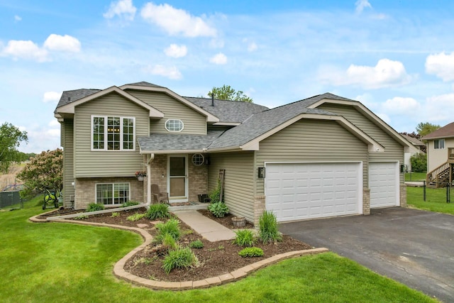 14380 Geneva Ave N, Hugo, MN 55038 - tri-level home featuring roof with shingles, driveway, a front yard, and an attached garage
