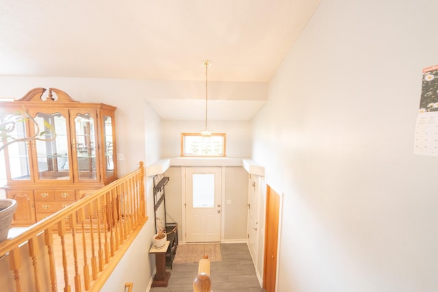 1320 18th St SE, Owatonna, MN 55060 - foyer entrance featuring wood finished floors, stairs, and a chandelier