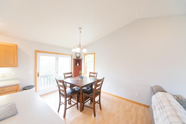 1320 18th St SE, Owatonna, MN 55060 - dining space featuring a chandelier, lofted ceiling, and light wood-type flooring