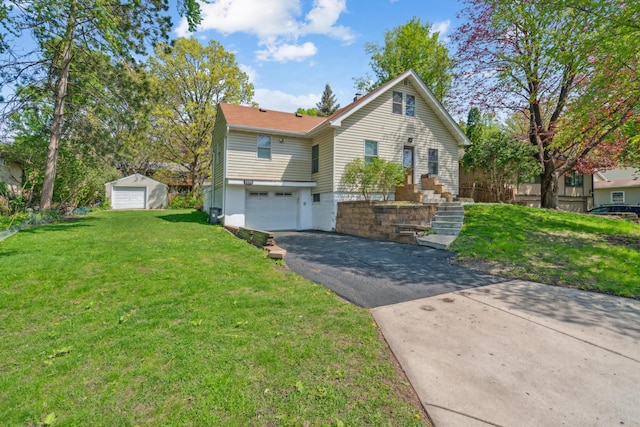 1775 Morgan Ave, Saint Paul, MN 55116 - view of front of property with asphalt driveway, an attached garage, and a front lawn