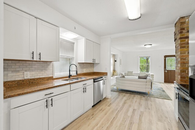 1775 Morgan Ave, Saint Paul, MN 55116 - kitchen featuring a sink, stainless steel dishwasher, open floor plan, light wood finished floors, and white cabinetry