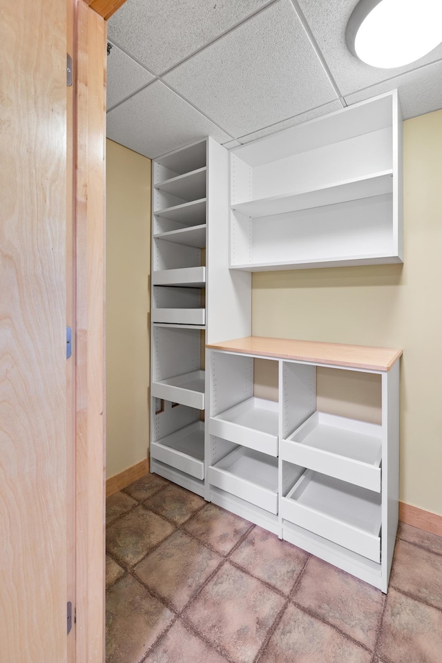 walk in closet with a paneled ceiling