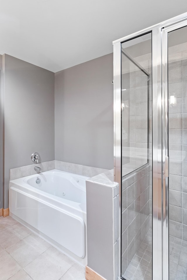 full bathroom with a bath, a stall shower, and tile patterned floors
