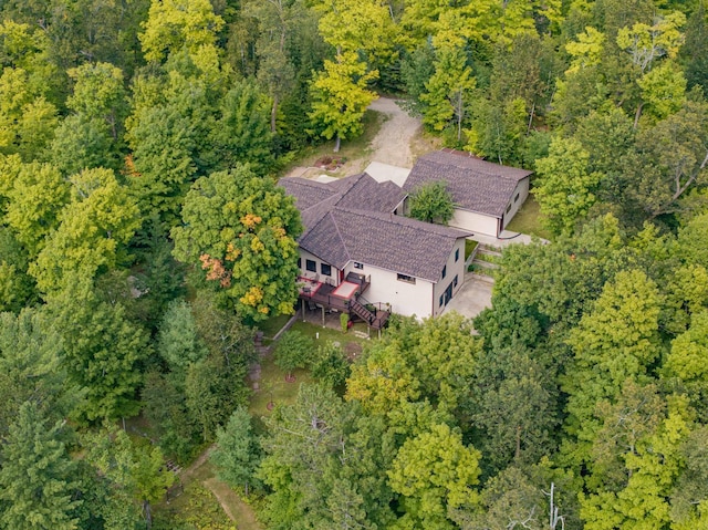 birds eye view of property with a view of trees