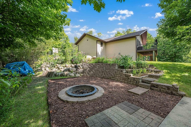 view of yard with a deck and a fire pit