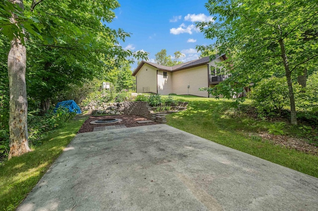 view of yard with a patio area and a fire pit
