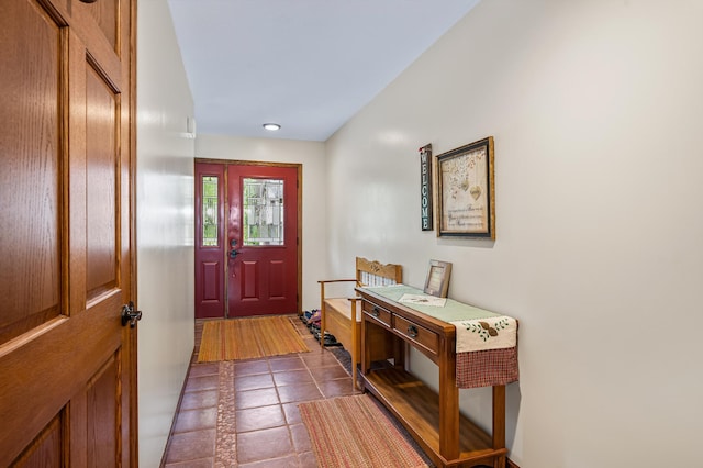 entryway featuring dark tile patterned flooring