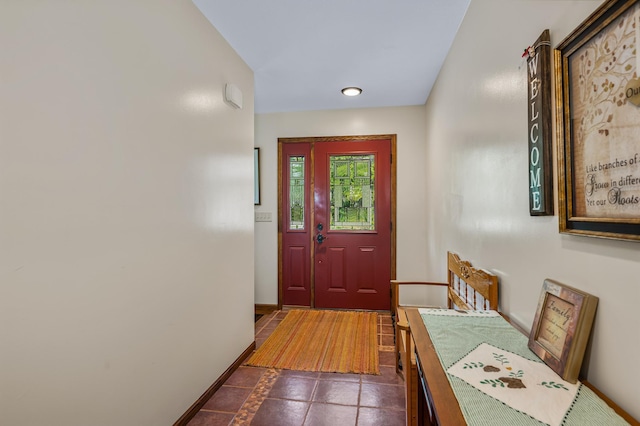 doorway featuring baseboards and recessed lighting