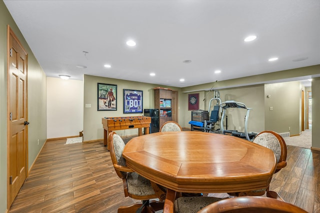 dining room featuring baseboards, recessed lighting, and wood finished floors