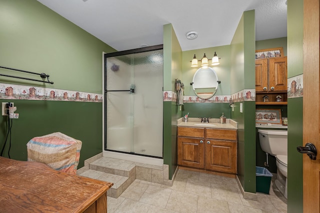 bathroom with vanity, toilet, tile patterned flooring, and a shower stall