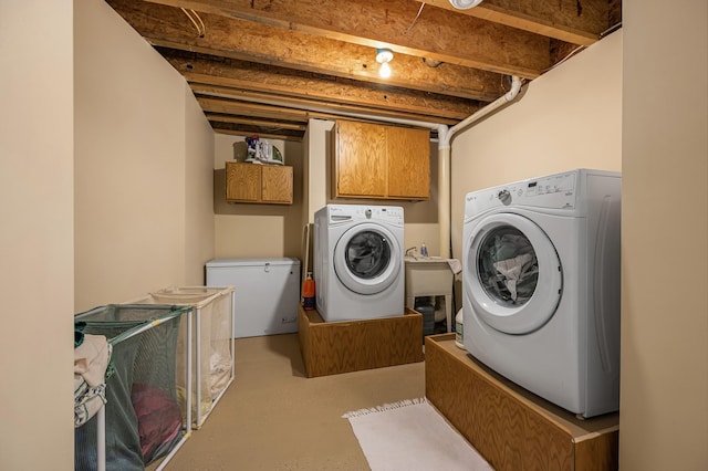 laundry room with cabinet space and washing machine and clothes dryer