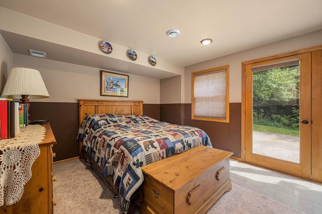 bedroom with access to outside, baseboards, and visible vents