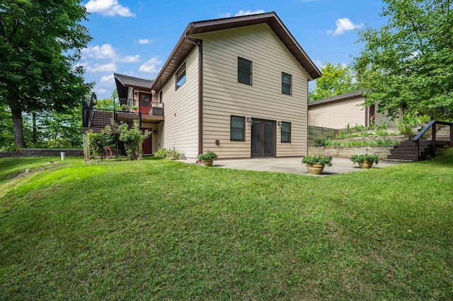 rear view of house with a yard, a patio area, and stairs