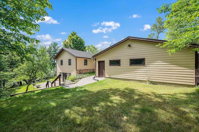 rear view of house featuring a lawn