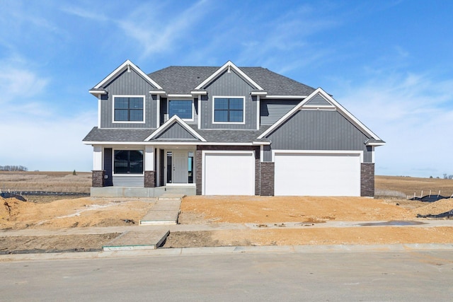 craftsman-style house featuring stone siding, a shingled roof, and a garage