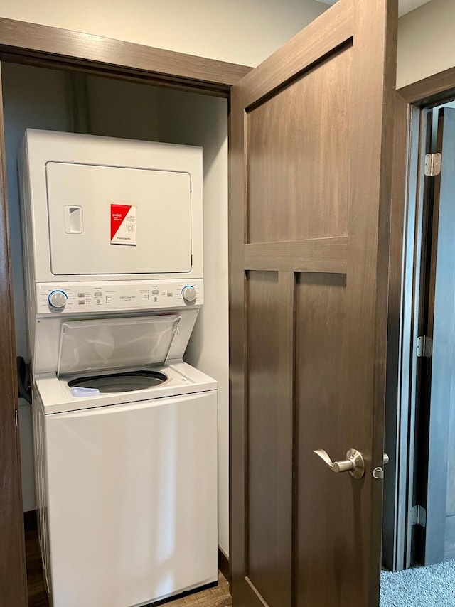 washroom featuring laundry area and stacked washer and dryer
