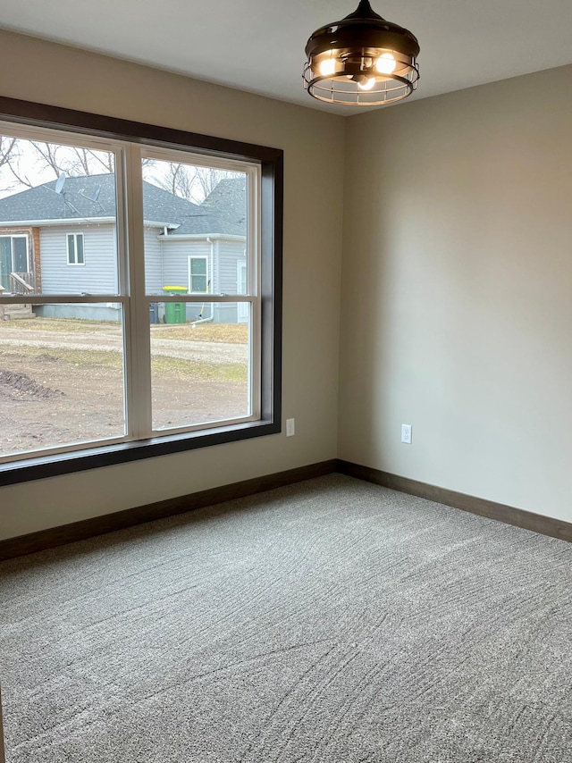 empty room with carpet flooring and baseboards