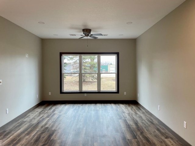 spare room with a ceiling fan, dark wood-style flooring, baseboards, and recessed lighting