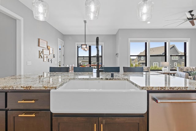 4152 Hummingbird Ct N, Lake Elmo, MN 55042 - kitchen with stainless steel dishwasher, a ceiling fan, dark brown cabinets, and plenty of natural light