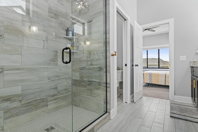 4152 Hummingbird Ct N, Lake Elmo, MN 55042 - bathroom with a stall shower, toilet, ensuite bathroom, baseboards, and a ceiling fan