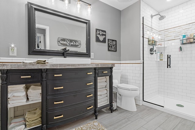 4152 Hummingbird Ct N, Lake Elmo, MN 55042 - full bathroom featuring a stall shower, toilet, vanity, wood finished floors, and a wainscoted wall