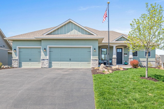 4152 Hummingbird Ct N, Lake Elmo, MN 55042 - craftsman-style house featuring stone siding, a garage, driveway, board and batten siding, and a front yard
