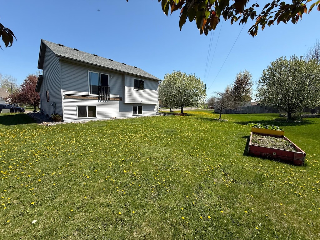 rear view of house featuring a lawn
