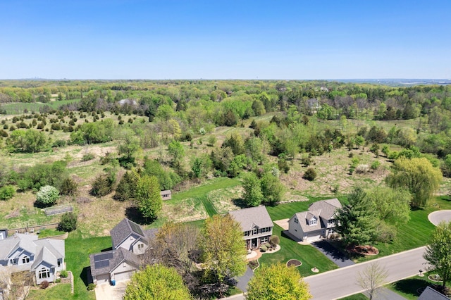 aerial view of residential area featuring a heavily wooded area