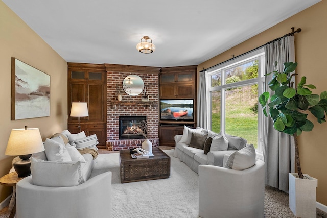 living area featuring a brick fireplace and carpet floors