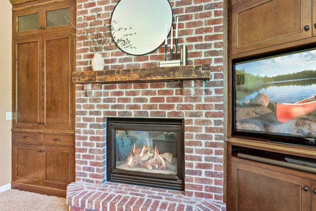 detailed view of a fireplace and carpet flooring