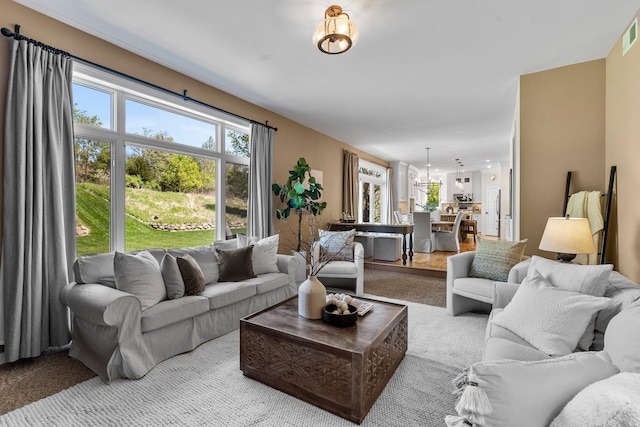 carpeted living room with healthy amount of natural light