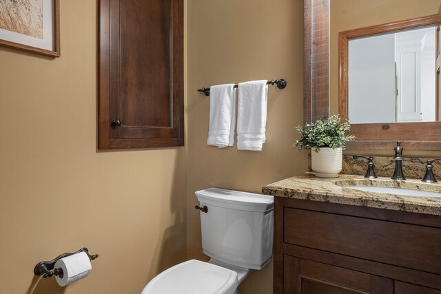 bathroom with toilet and vanity