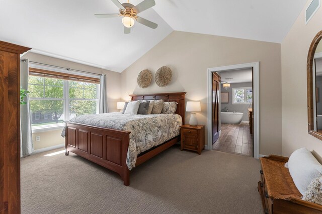 bedroom with vaulted ceiling, light carpet, connected bathroom, ceiling fan, and baseboards