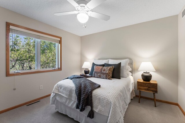 bedroom with baseboards, carpet flooring, and a ceiling fan