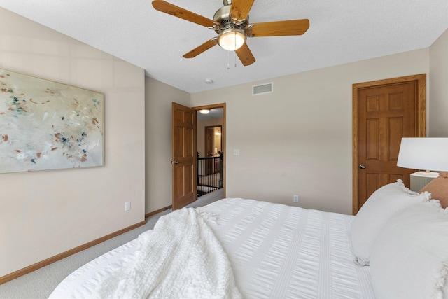 carpeted bedroom featuring baseboards and ceiling fan