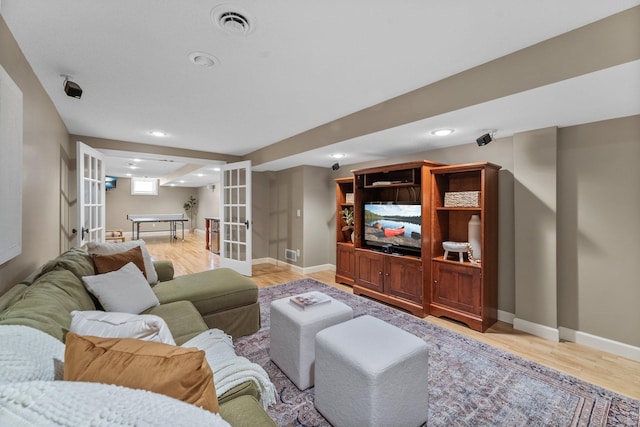 living area with french doors, light wood-style floors, recessed lighting, and baseboards