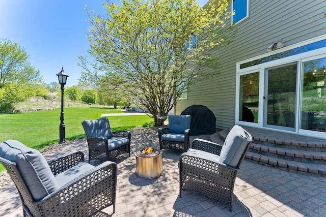 view of patio featuring an outdoor living space with a fire pit
