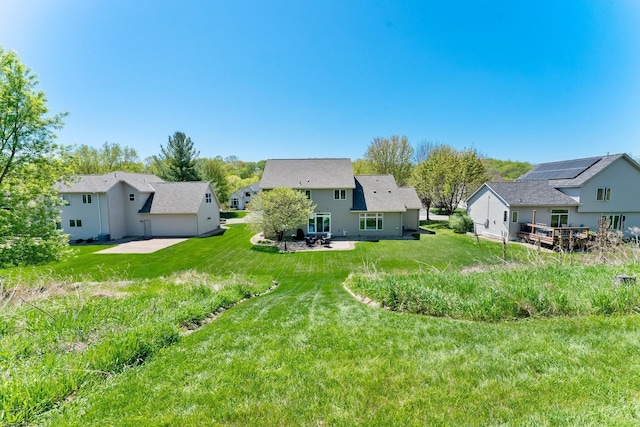 rear view of house with a lawn, a patio area, and a residential view