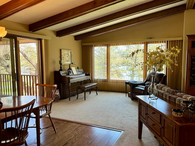 living area featuring lofted ceiling with beams